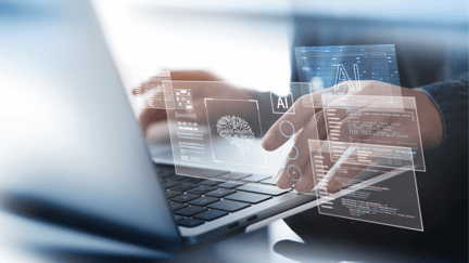 A holographic image demonstrating AI use cases in front of a person using a laptop.