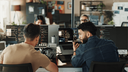 Employees using computers to work in a modern office.