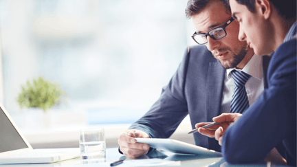 Two executives create a plan for unexpected IT costs on an iPad.