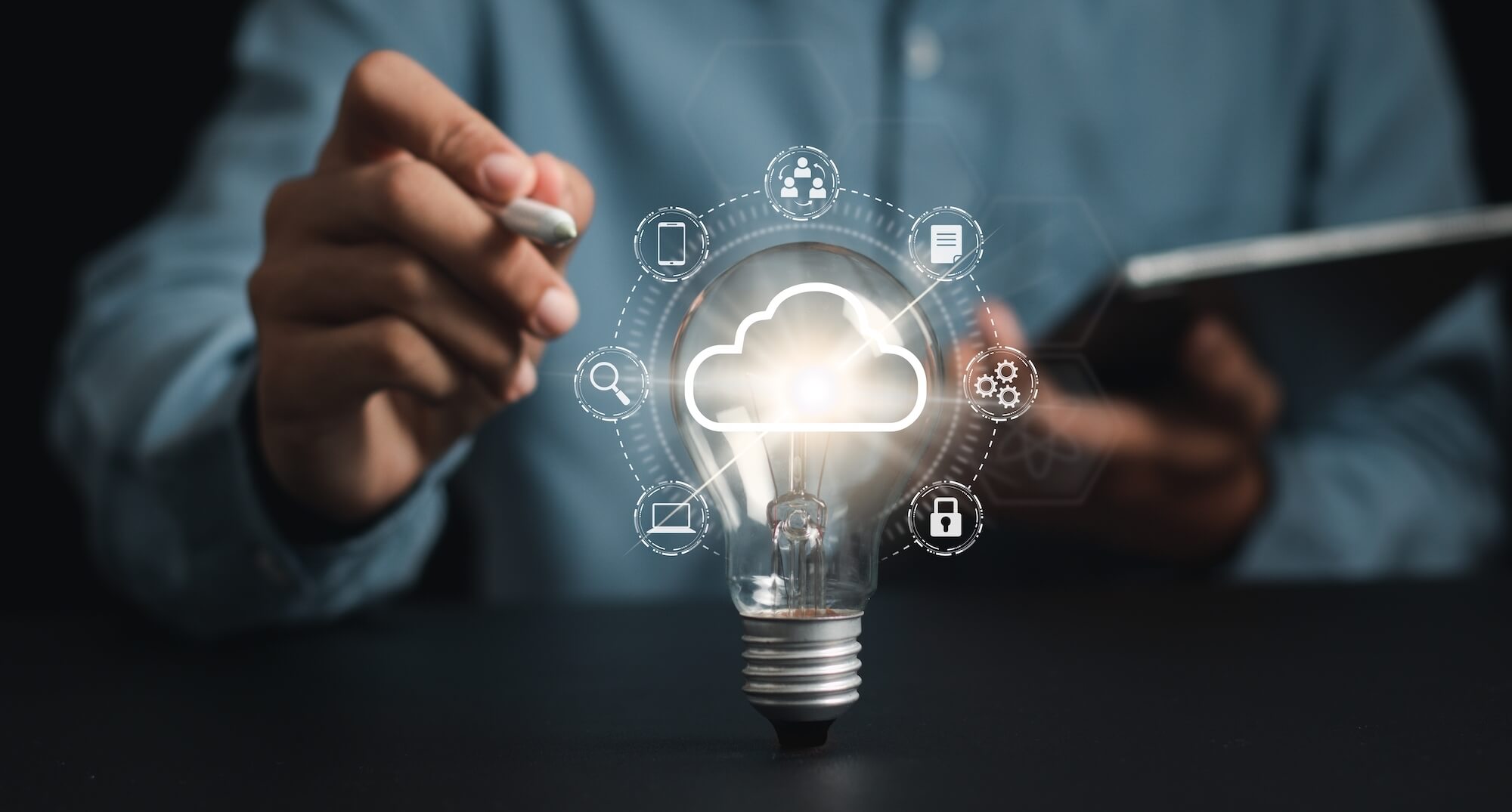 Man holding tablet with a light bulb