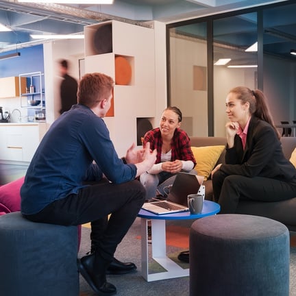 Ntiva job interview taking place in casual but busy modern office featuring three young professionals