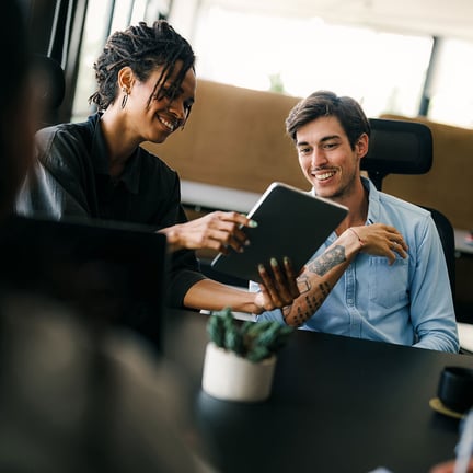 business project team working together in a meeting room at the office looking at tablet device
