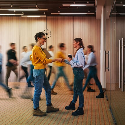 Businesswoman discussing on background of crowd office employees at coworking center.