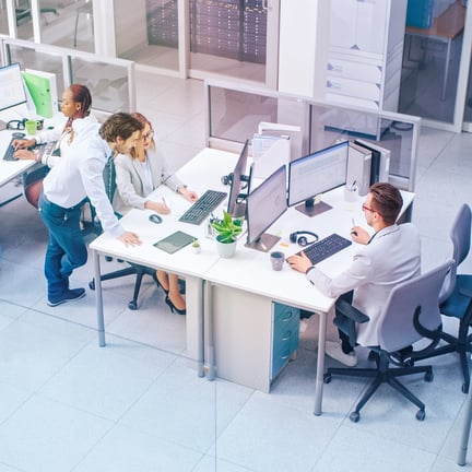 In the Bright Busy Office Rows of Young Professionals Working on Desktop Computers