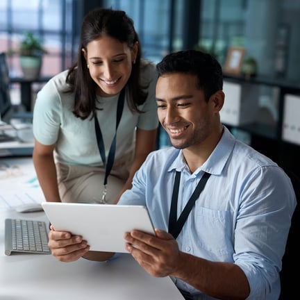 businesspeople collaborating over tablet smiling