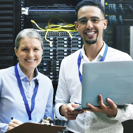 Shot of two technicians working together in a server room