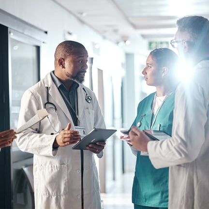 Doctors working together on their tablets