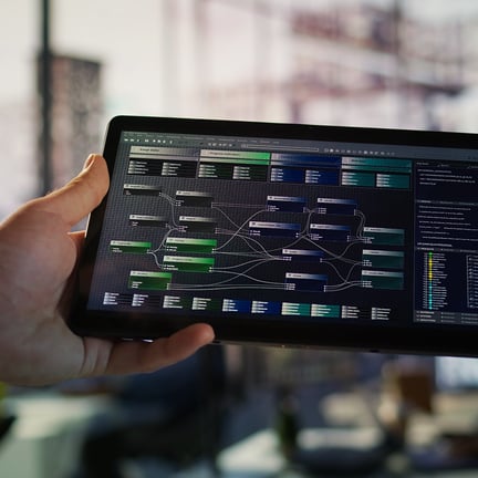 Software engineer using tablet to design algorithms and run vulnerability testing