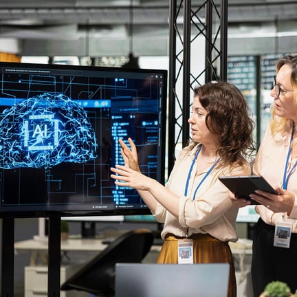 Team of coworkers using strategic artificial intelligence cloud computing to conduct data analysis