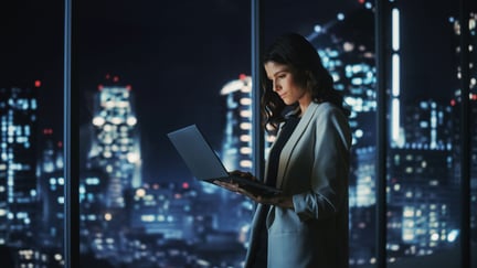 Young businesswoman standing and using a Laptop