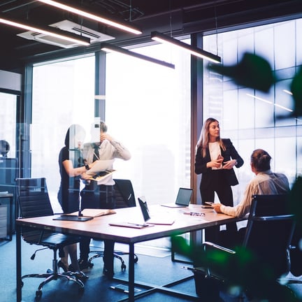 ctive business meeting in modern conference room among digital devices and documentation