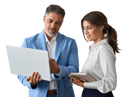 A man in a blue suit discusses content on a laptop with a woman holding a notepad