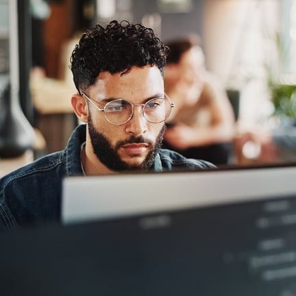 cybersecurity professional working on desktop concentrating