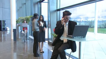 man on phone and computer