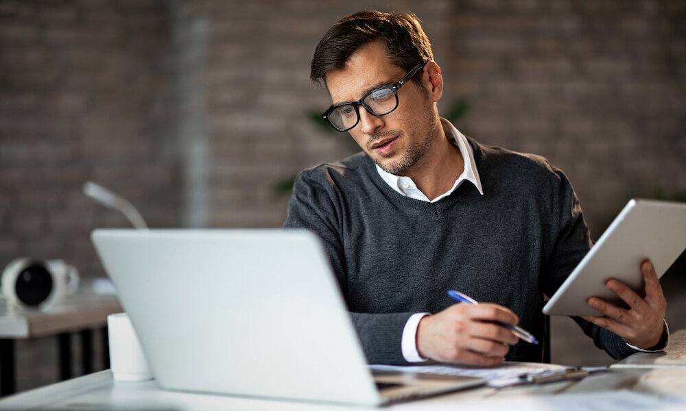 Man at desk looking confused. 