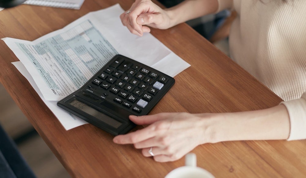 Woman calculating IT costs. 