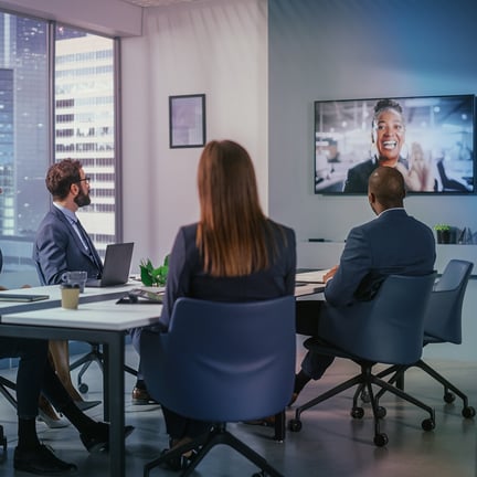 Business professionals attending a video conference in a modern meeting room