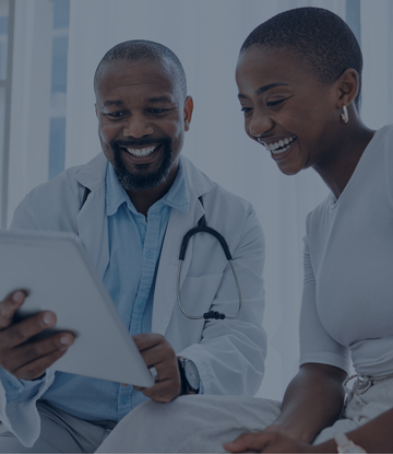 Doctor reviewing data on an iPad with a patient.