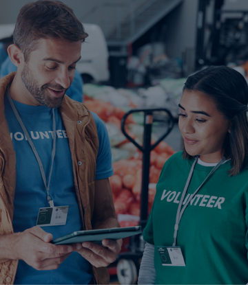 Nonprofit volunteers review information on an iPad. 